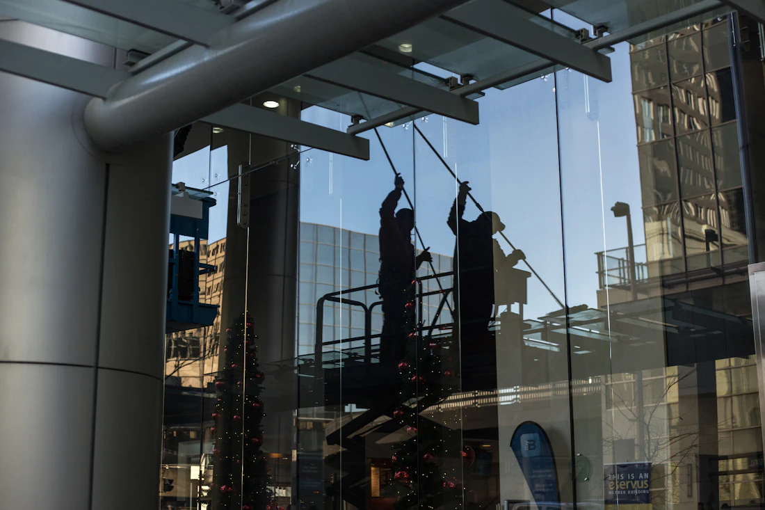 Technician on a lift platform performing elevated commercial cleaning