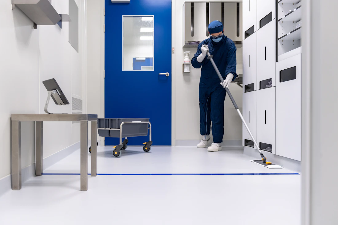 Professional cleaning technician in commercial protective gear