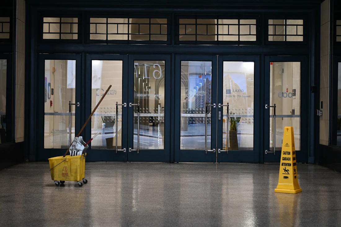 Commercial entrance being serviced with safety signage in place